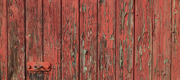 Old wall of corrugated iron with bolts, nuts and repairs in the central part of Sri Lanka