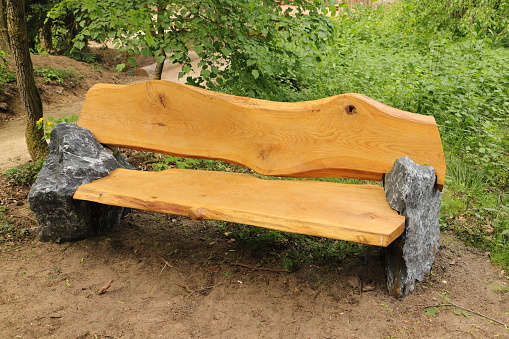 Park Bench at Hyde Park in City of Westminster, London, with people visible in the background.