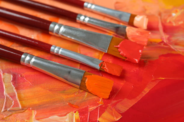 A collection of used paintbrushes in a jar, photographed in soft natural light with shallow depth of field. The image conveys a sense of creativity, artistic atmosphere, and daily life inside a working artist’s studio. Ideal for themes of inspiration, craftsmanship, and visual storytelling.