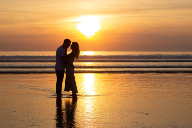 istock Gentle family walking on beach at sundown 1443575679