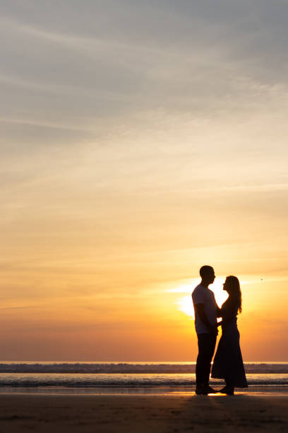 istock Gentle family walking on beach at sunset 1443575711