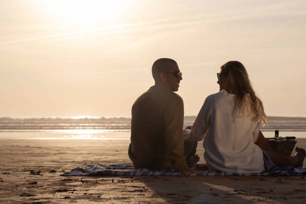 istock Happy couple at picnic at sunset 1443575717