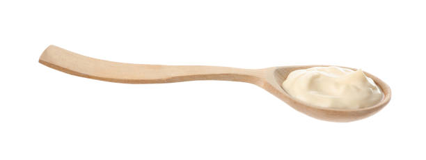 istock Wooden spoon with mayonnaise isolated on white 1443576292