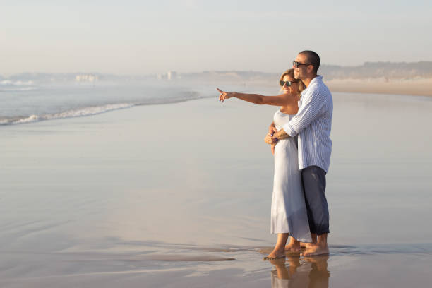 istock Satisfied Caucasian couple spending time at beach 1443576454