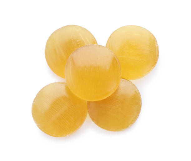 istock Yellow cough drops on white background, top view 1443576516