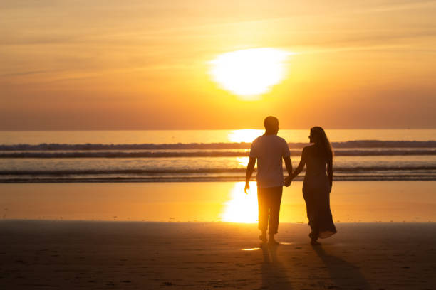 istock Tender family walking on beach at sunset 1443576626