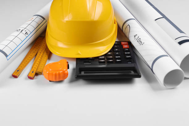 istock Construction drawings, safety hat, calculator, tape measure and folding ruler on white background 1443577239