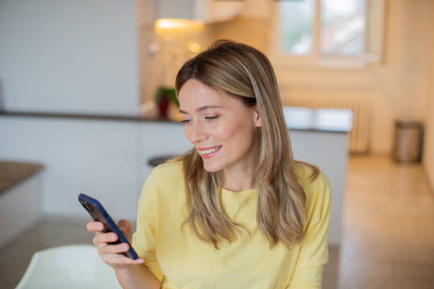 istock Happy young woman using phone 1443578996