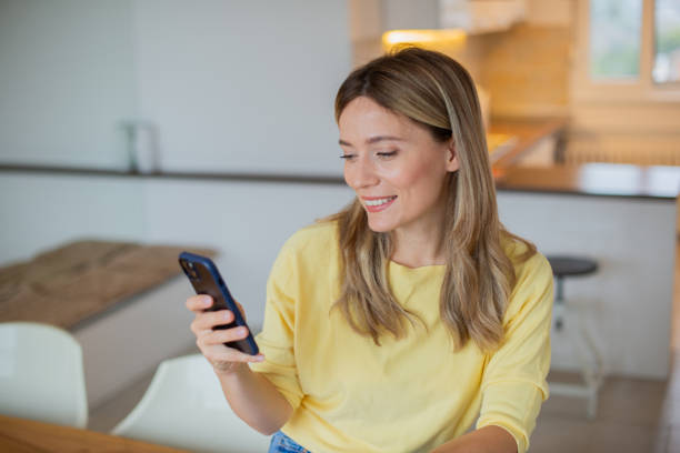 istock Happy young woman using phone 1443579027