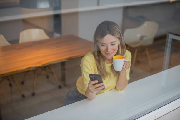 istock Happy young woman using phone 1443579139