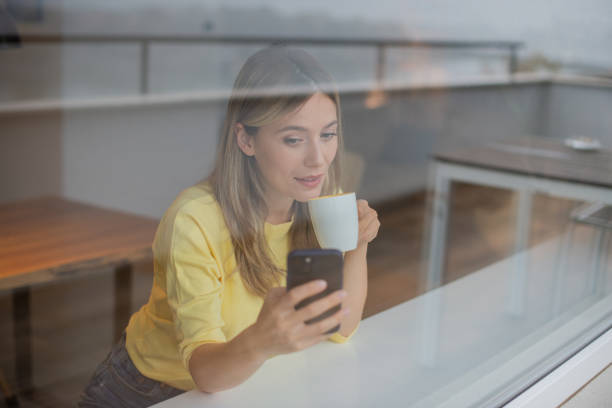 istock Happy young woman using phone 1443579150