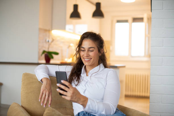 istock Happy young woman using phone 1443579218