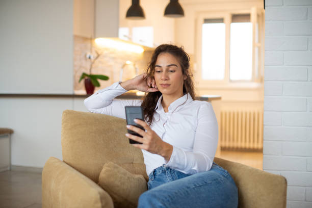 istock Happy young woman using phone 1443579242