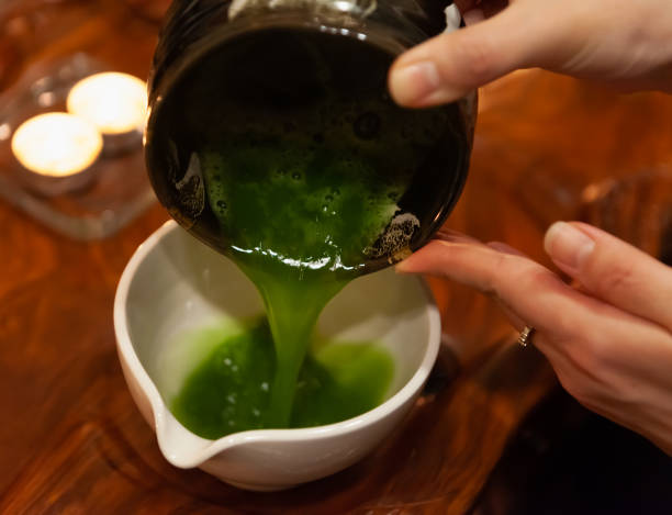 istock female hands with whipped matcha tea, green matcha tea is poured into a cup 1443580983