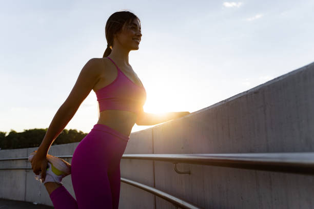 istock Attractive female athlete stretching her muscles before training 1443581085