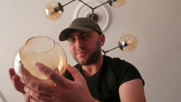 istock Young man wearing chandelier for decoration 1443581138