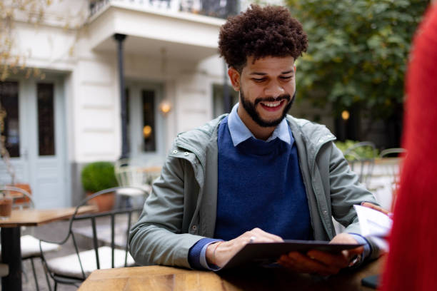 istock Happy young man sitting in a local restaurant 1443581396