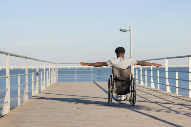 istock Strong Black man riding wheelchair at seafront 1443581431