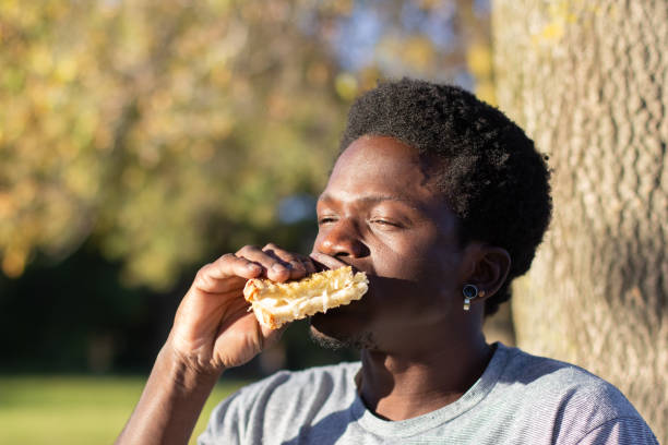 istock Stylish Black man having lunch in city park 1443581441