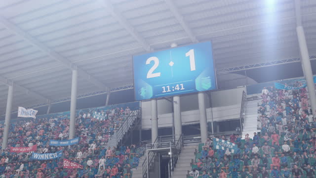 Football Soccer Stadium Championship Match, Scoreboard Screen Showing Score of 2:1. Crowd of Fans Cheering, Happy, Having Fun. Sport Channel Television Advertising Playback Concept