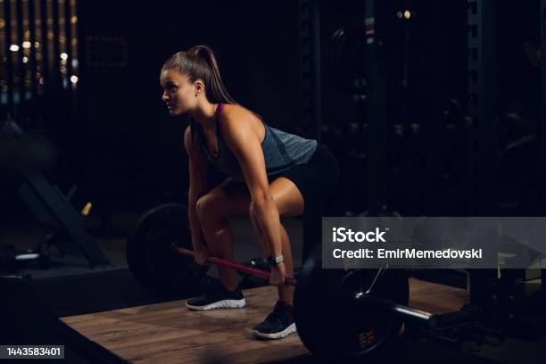 Young Woman Lifting Barbell At Gym Stock Photo - Download Image Now - Weight Training, Weights, Active Lifestyle