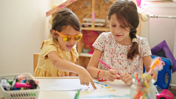istock Sisters at home drawing and painting together 1443583555