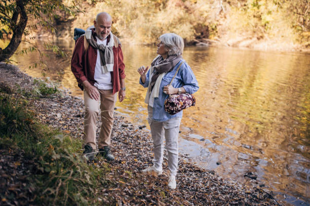 istock Mature couple taking a walk by the river 1443585445