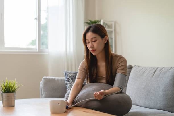 istock Young women check blood pressure at home 1443587669