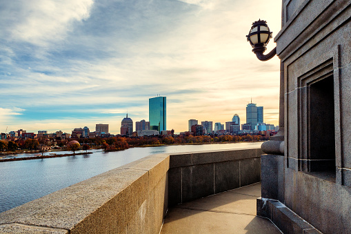 View from a Longfellow Bridge tower, across the Charles River, of an autumn sunset and the Boston skyline.