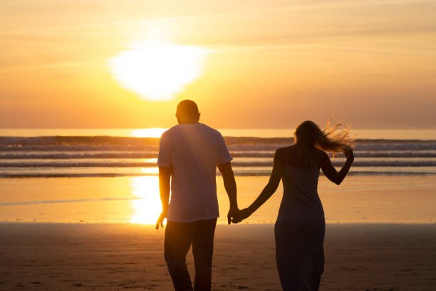 istock Loving family walking on beach at sunset 1443589564