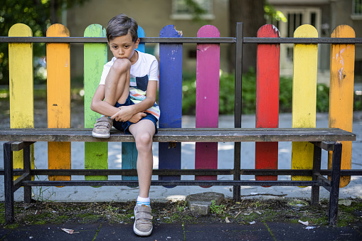 Boy feeling lonely on playground