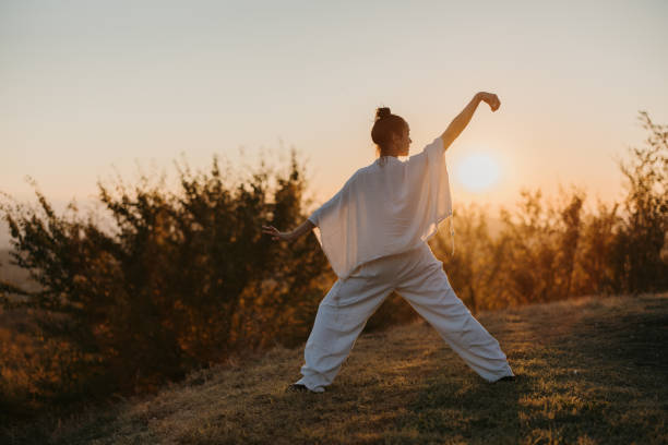 istock Woman doing tai chi in sunset 1443592180