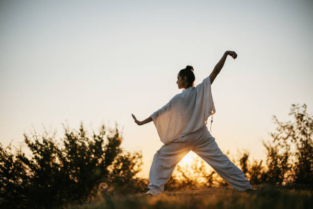 istock Woman exercise tai chi in sunset 1443592193