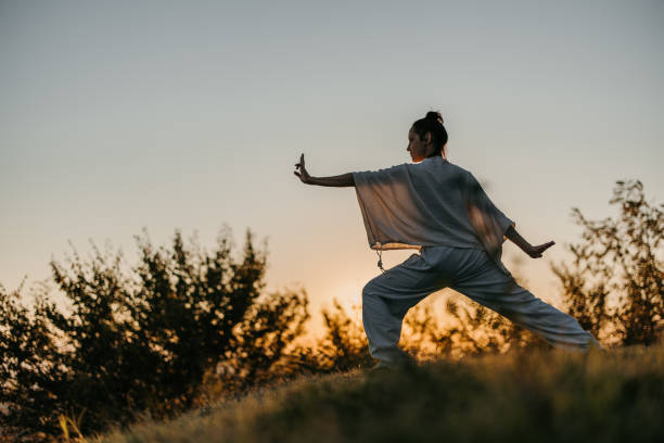 istock Woman doing tai chi in sunset 1443592208