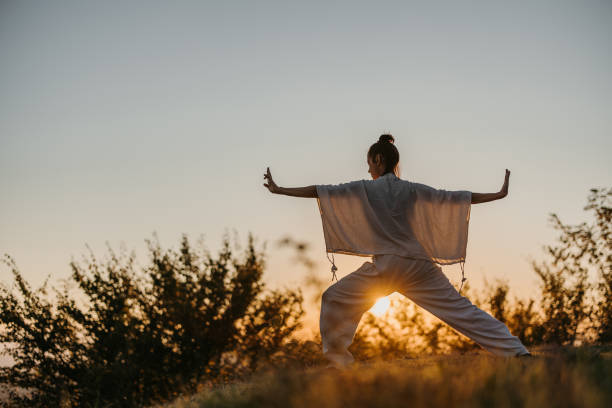 istock Woman doing tai chi in sunset 1443592217