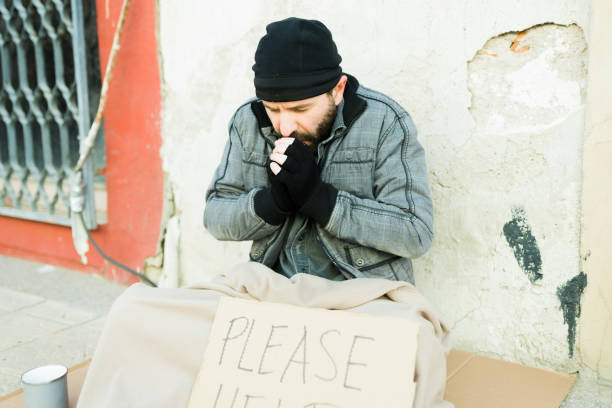 istock Miserable homeless beggar feeling very cold outside 1443592580