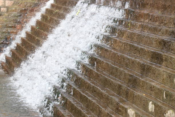 Water is flowing on steps that is built on a small overflow dam used to store and provide water for dry season