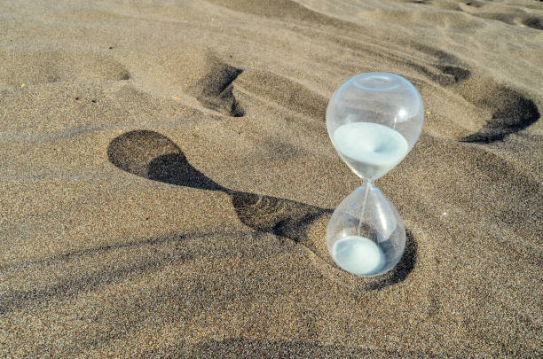 istock Hourglass Clock on the Sand Beach 1443594908