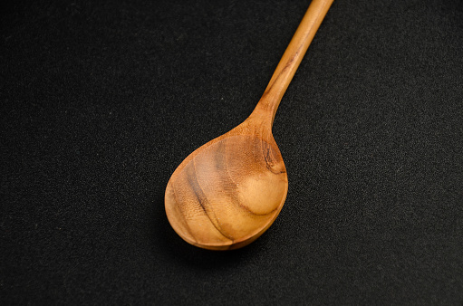 The Wooden Spoon on Black Background