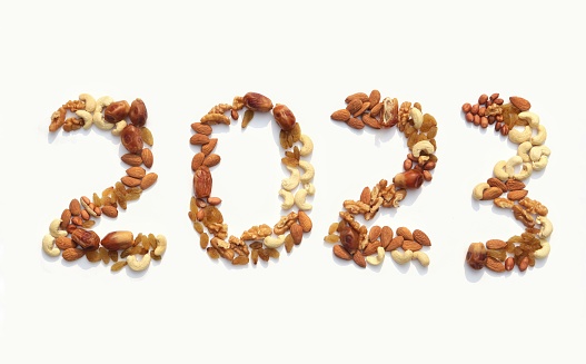 2023 Written Dry Fruits Like Walnut, Cashew, Almond, Peanut, Date Palm and Raisin Isolated on White Background, Happy New Year 2023 Conceptual, Photo, Healthy Lifestyle Food.