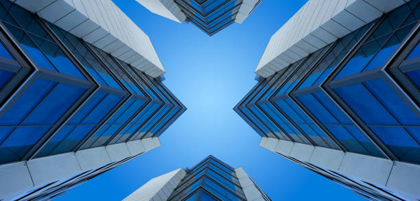 Looking up to the sky with modern skyscraper buildings in blue