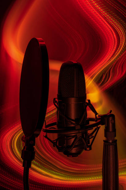 istock closeup of a microphone with red lights in the background 1443603747