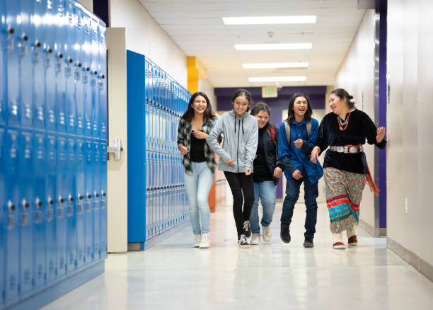 A group of happy students walking on the corridor stock photo