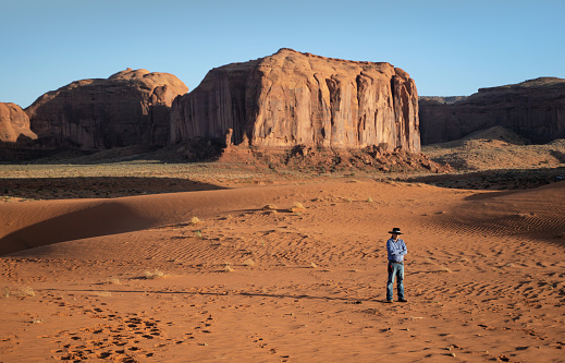 Navajo man standing for a portrait in the navajo desert