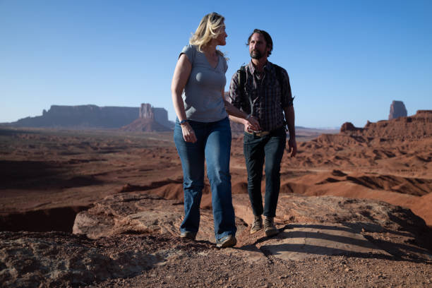 Young couple walking during sunset in Monument Valley park, Utah