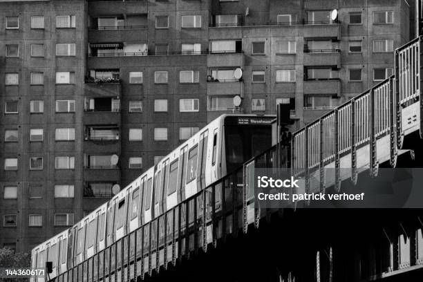 Black And White Picture Of A Subway Train In Berlin In Front Of A Brutalist Building Stock Photo - Download Image Now