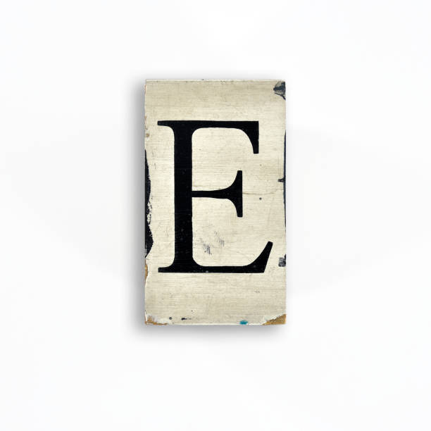 istock capital letter with serif on wood smeared with paint on white background, alphabet - E 1443606651