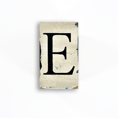 Photograph of letters with serifs printed on a painted wooden board. Nice grunge style in flat lay on white background. Check out more letters: