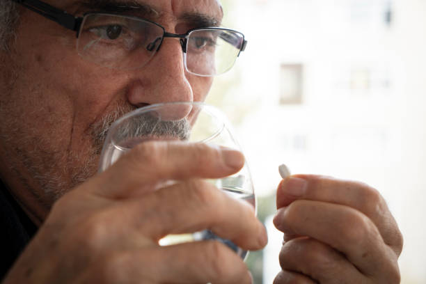 istock Senior man taking his medicine 1443606758
