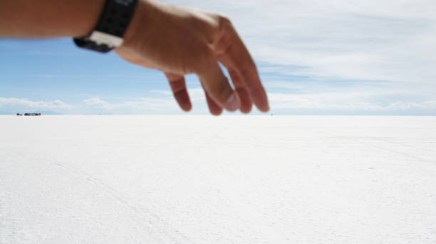 istock Hand catching Salar de Uyuni horizon 1443607103